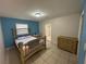 Bedroom with light blue walls and a double bed at 6928 E 29Th Ave, Tampa, FL 33619