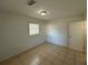 Bright bedroom with tile floors and a window at 6928 E 29Th Ave, Tampa, FL 33619