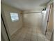 Small bedroom with tile floors and a window at 6928 E 29Th Ave, Tampa, FL 33619