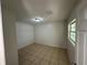 Simple bedroom with tiled floor and ample natural light at 6928 E 29Th Ave, Tampa, FL 33619