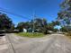 A light blue house sits on a corner lot with mature trees and a large yard at 6928 E 29Th Ave, Tampa, FL 33619