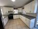 Modern kitchen with white cabinets and granite counters at 6928 E 29Th Ave, Tampa, FL 33619