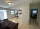 Open concept kitchen with island and view into living room at 6928 E 29Th Ave, Tampa, FL 33619