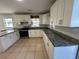 Modern kitchen with white cabinets and granite counters at 6928 E 29Th Ave, Tampa, FL 33619