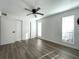 Bright bedroom with wood-look floors and ceiling fan at 8714 Mallard Reserve Dr # 104, Tampa, FL 33614