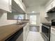 Modern kitchen with white cabinets and wood countertops at 8714 Mallard Reserve Dr # 104, Tampa, FL 33614