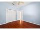 Light blue bedroom with wood floors and double-door closet at 9122 65Th N Way, Pinellas Park, FL 33782