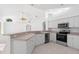 Modern kitchen featuring white cabinets, stainless steel appliances, and a breakfast bar at 9122 65Th N Way, Pinellas Park, FL 33782