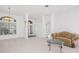 Bright living room with tile floors, a couch, and glass-top coffee table at 9122 65Th N Way, Pinellas Park, FL 33782