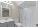 Bathroom with gray vanity, glass shower, and white toilet at 4522 Bay Spring Ct, Tampa, FL 33611