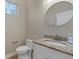 Small half bathroom with granite countertop and oval mirror at 4522 Bay Spring Ct, Tampa, FL 33611