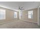 Spacious bedroom with ceiling fan and neutral carpeting at 4522 Bay Spring Ct, Tampa, FL 33611