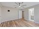 Bedroom with ceiling fan, wood-look floors, and ensuite bathroom at 4522 Bay Spring Ct, Tampa, FL 33611
