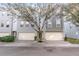 Modern two-story townhome with attached garage and tree-lined street at 4522 Bay Spring Ct, Tampa, FL 33611