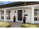 Front entrance with a modern door and potted plants at 100 Riviera Ne Way, St Petersburg, FL 33704