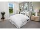 Guest bedroom with neutral tones, featuring a queen-size bed and natural light at 11279 Boundless Ter, Venice, FL 34293