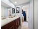 Double vanity bathroom with dark wood cabinets and tile floors at 12805 Mia Cir, Largo, FL 33774