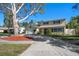 Charming two-story home with a well-manicured lawn and driveway at 12805 Mia Cir, Largo, FL 33774