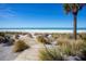 Wooden path leads to a pristine beach with a fire pit at 1600 Gulf Blvd # 1112, Clearwater, FL 33767