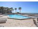 Community pool with lounge chairs overlooking the ocean at 1600 Gulf Blvd # 1112, Clearwater, FL 33767