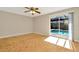 Bedroom featuring hardwood floors, large slider windows and an outdoor pool view at 18308 Felspar Way, Tampa, FL 33647