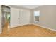 Bedroom featuring hardwood floors and a large closet and window with front yard view at 18308 Felspar Way, Tampa, FL 33647