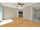 Bedroom featuring hardwood floors, large slider windows and access to the ensuite bathroom at 18308 Felspar Way, Tampa, FL 33647