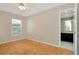 Bedroom featuring hardwood floors, a ceiling fan and access to the ensuite bathroom at 18308 Felspar Way, Tampa, FL 33647