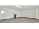 Spacious garage featuring a large roll-up door and neutral walls at 18308 Felspar Way, Tampa, FL 33647
