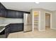 Well-equipped kitchen featuring a pantry, stainless steel refrigerator, and ample cabinet space at 18308 Felspar Way, Tampa, FL 33647