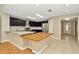 Open kitchen featuring granite countertops, stainless steel appliances, and dark cabinetry at 18308 Felspar Way, Tampa, FL 33647
