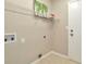 Neutral laundry room with a shelf, hookups, and a standard door at 18308 Felspar Way, Tampa, FL 33647