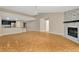 Spacious living room featuring a stone fireplace, and opening into an eat-in kitchen at 18308 Felspar Way, Tampa, FL 33647