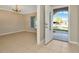 View of a bright, neutral-toned living room with tiled floors leading to the front entrance at 18308 Felspar Way, Tampa, FL 33647