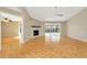 Spacious living room with a modern fireplace, parquet flooring, and sliding glass doors to the pool area at 18308 Felspar Way, Tampa, FL 33647