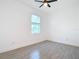 Simple bedroom with a window and ceiling fan at 211 Australian Dr, Rotonda West, FL 33947