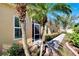 Landscaped side yard with walkway and tropical plants at 2322 Oakley Green Dr # 2322, Sun City Center, FL 33573