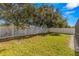 Fenced backyard with grassy area and mature trees at 27500 Sky Lake Cir, Wesley Chapel, FL 33544