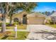 Attractive single-story home with a two-car garage and well-maintained landscaping at 27500 Sky Lake Cir, Wesley Chapel, FL 33544