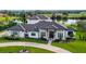 Luxury home with circular driveway, lake views, and meticulously landscaped grounds at 323 Hawk Talon Dr, Lithia, FL 33547