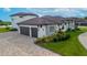 Home features a three car garage and beautifully landscaped grounds at 323 Hawk Talon Dr, Lithia, FL 33547