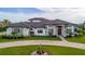 Elegant home features a stone facade, paved driveway, and lush landscaping at 323 Hawk Talon Dr, Lithia, FL 33547