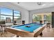 Game room with pool table, large windows, and bar stools at 323 Hawk Talon Dr, Lithia, FL 33547