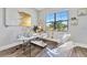 Modern home office with a large window and hardwood floors at 323 Hawk Talon Dr, Lithia, FL 33547