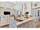 Island kitchen with marble countertops, gray cabinets, and a large sink at 323 Hawk Talon Dr, Lithia, FL 33547