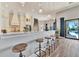 Modern kitchen with white cabinets, marble countertops, and an island with bar seating at 323 Hawk Talon Dr, Lithia, FL 33547