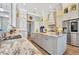 Gourmet kitchen boasting marble countertops, stainless steel appliances, and a large island at 323 Hawk Talon Dr, Lithia, FL 33547