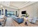 Open concept living room with sectional sofa, hardwood floors, and sliding glass doors to pool at 323 Hawk Talon Dr, Lithia, FL 33547