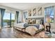 Spacious main bedroom with king-size bed, sitting area and water views at 323 Hawk Talon Dr, Lithia, FL 33547