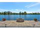 Lakefront patio with fire pit and gorgeous water views at 323 Hawk Talon Dr, Lithia, FL 33547